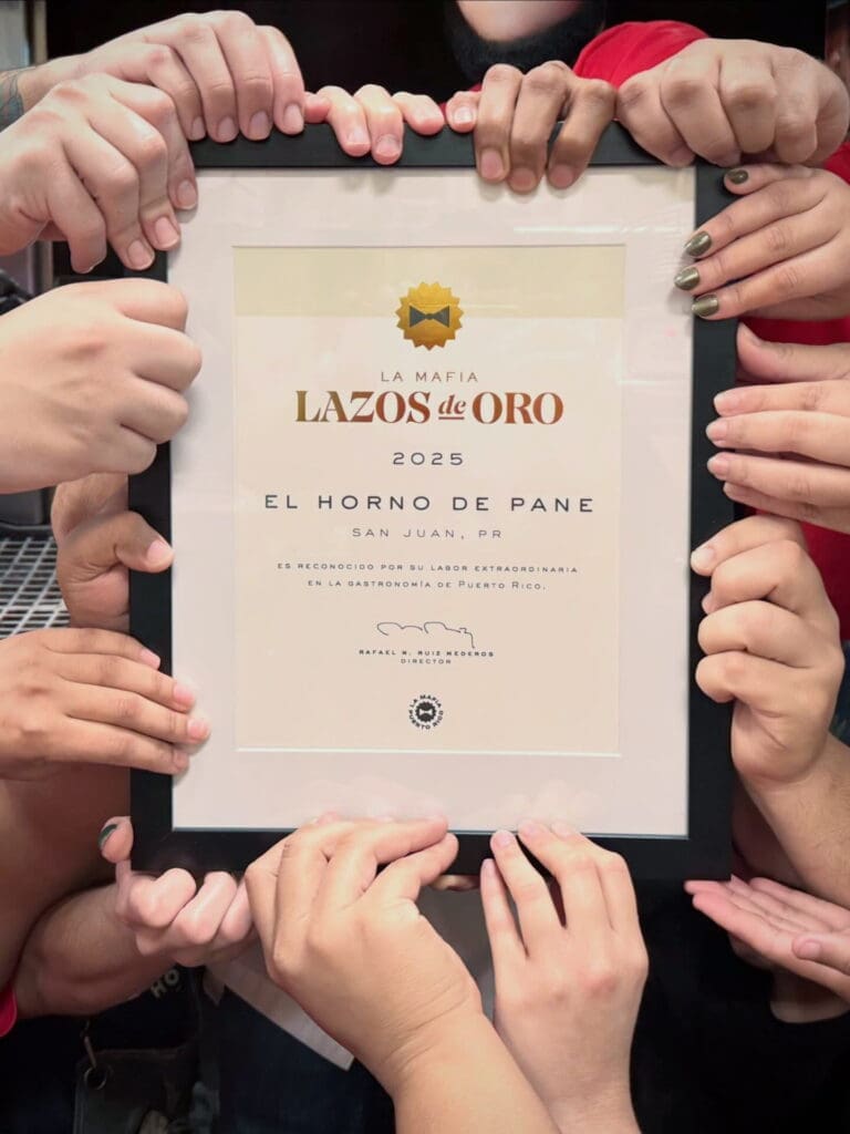 Many hands holding up the lazo de oros awards